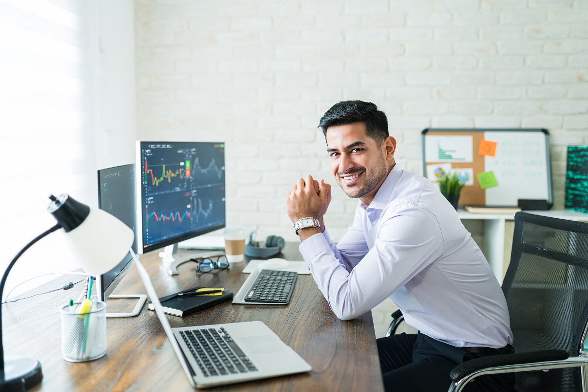 Happy Attractive Young Stock Broker Working At Home