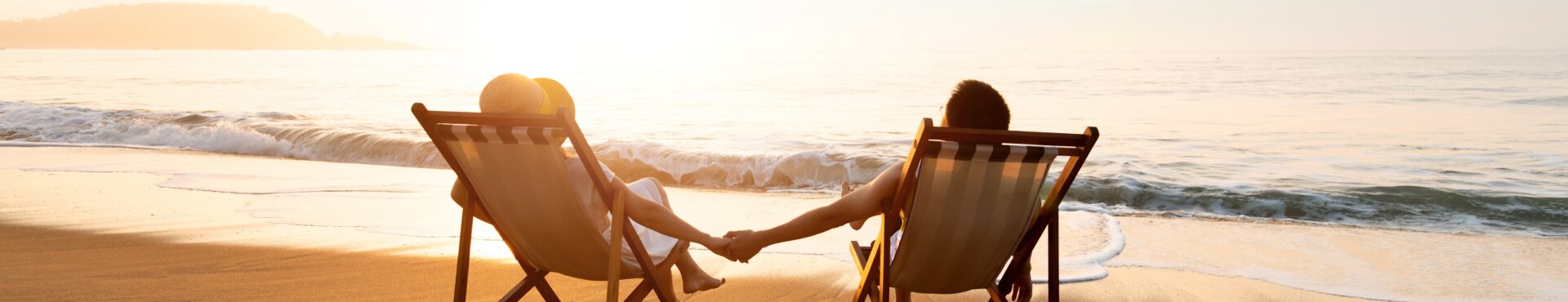 Young Couple Sunbathing On Beach Chair