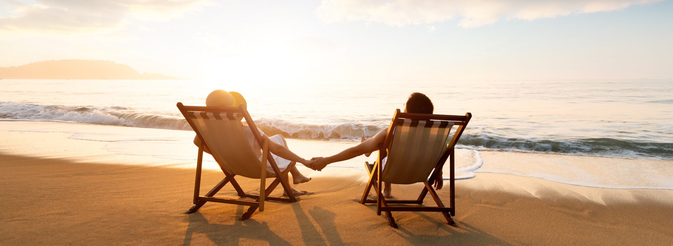 Young Couple Sunbathing On Beach Chair