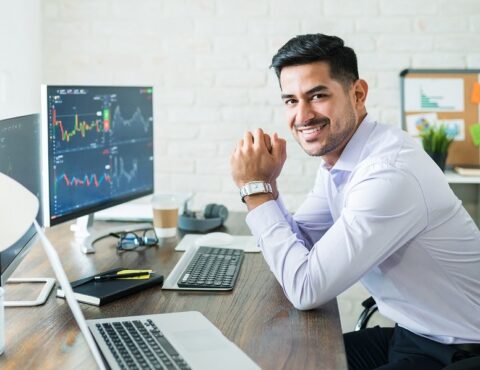 Happy Attractive Young Stock Broker Working At Home