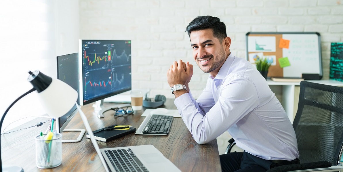 Happy Attractive Young Stock Broker Working At Home