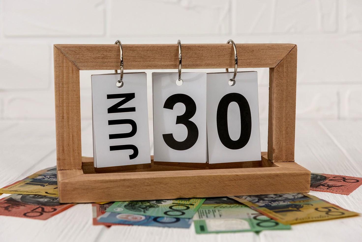 Wooden Calendar With Australian Dollar Banknotes Closeup